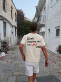 Don't Follow Me I'm Lost Too beige T-shirt worn in a street