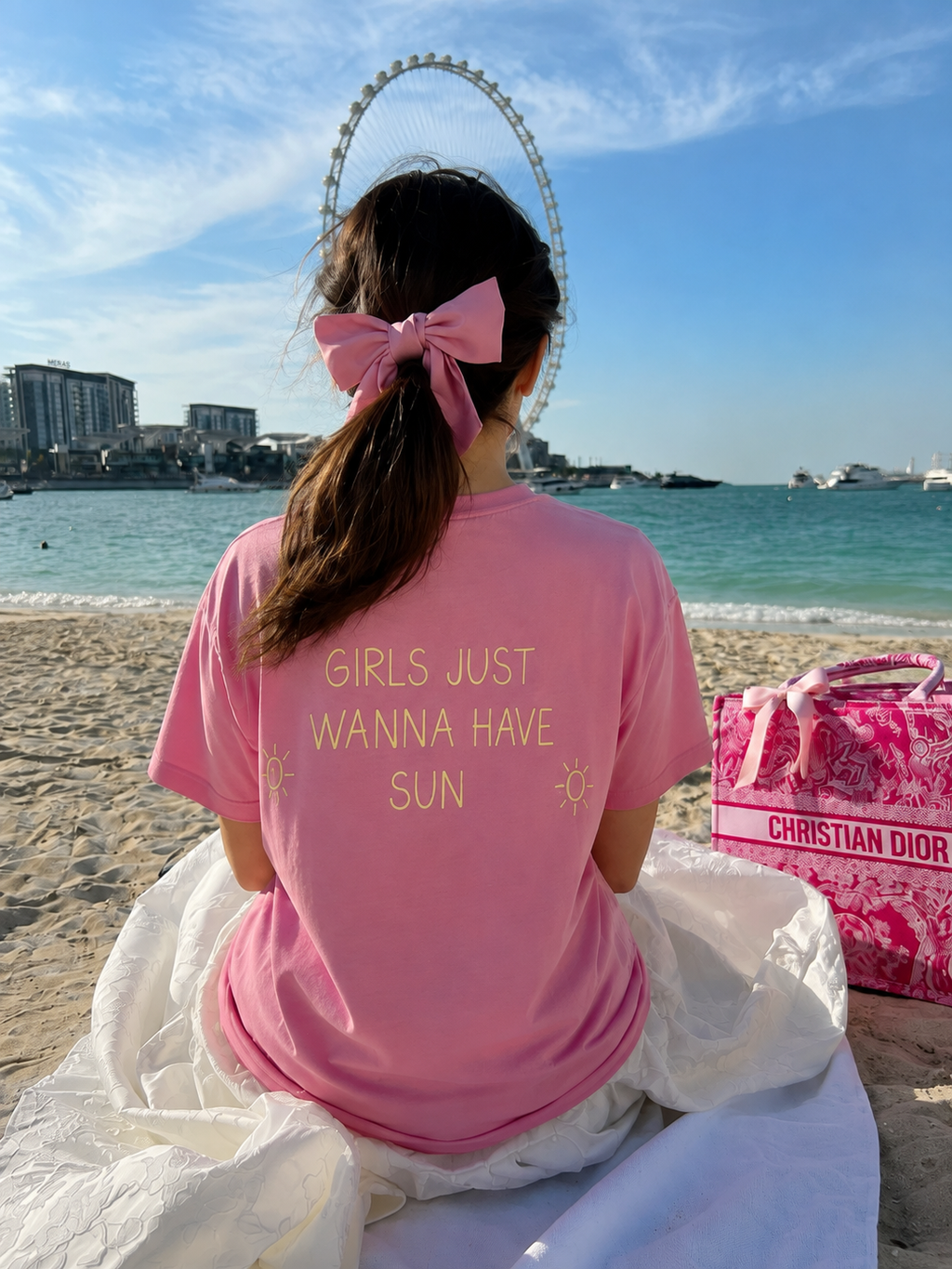 Girls Just Wanna Have Sun pink T-shirt worn at the beach
