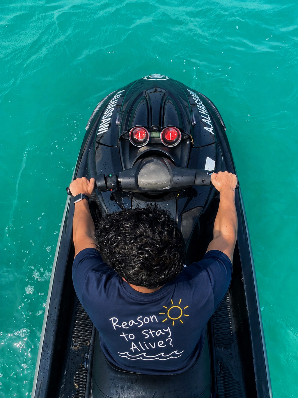 Reason to Stay Alive? navy T-shirt worn on a jet ski